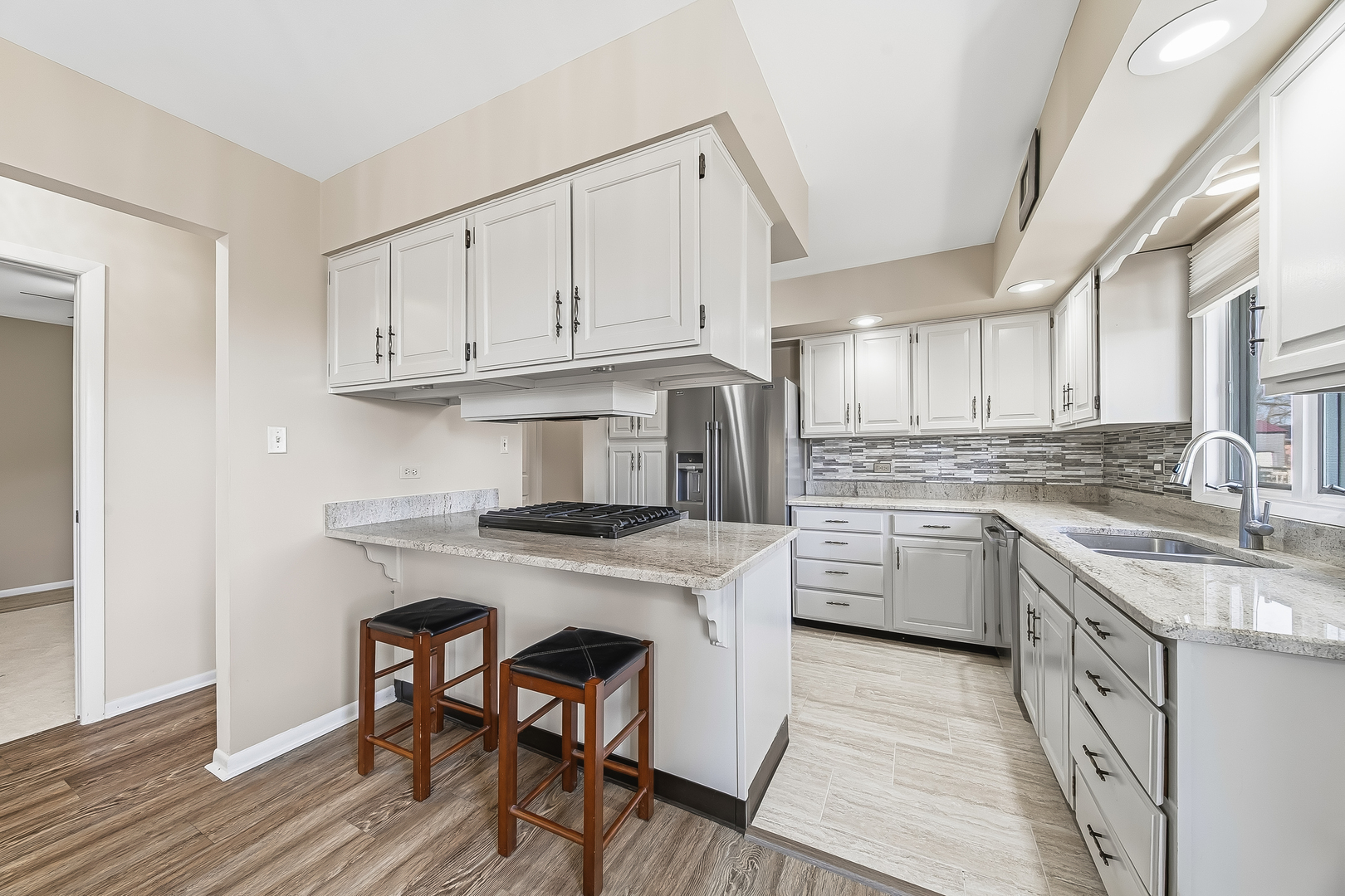 18317 Harper Street Lansing, IL 60438 - Photo 5 of 26 a kitchen with cabinets wooden floor and a sink