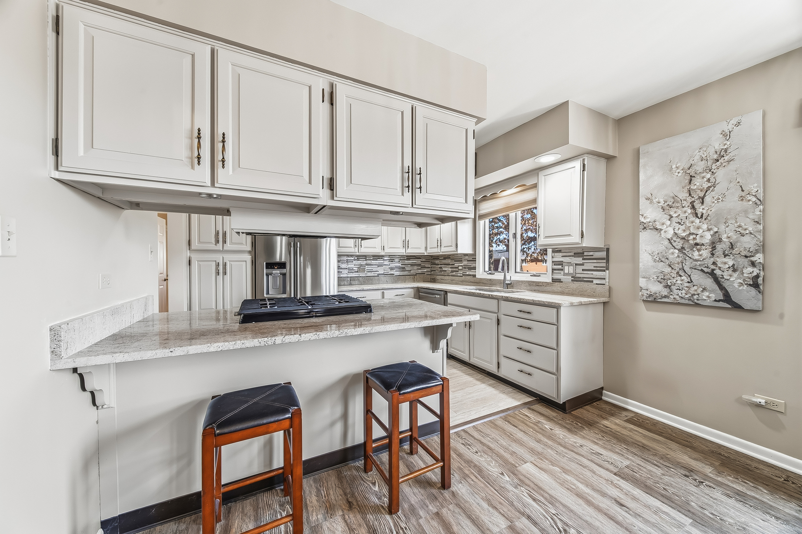 18317 Harper Street Lansing, IL 60438 - Photo 7 of 26 a kitchen with stainless steel appliances granite countertop a stove a sink dishwasher and cabinets with wooden floor