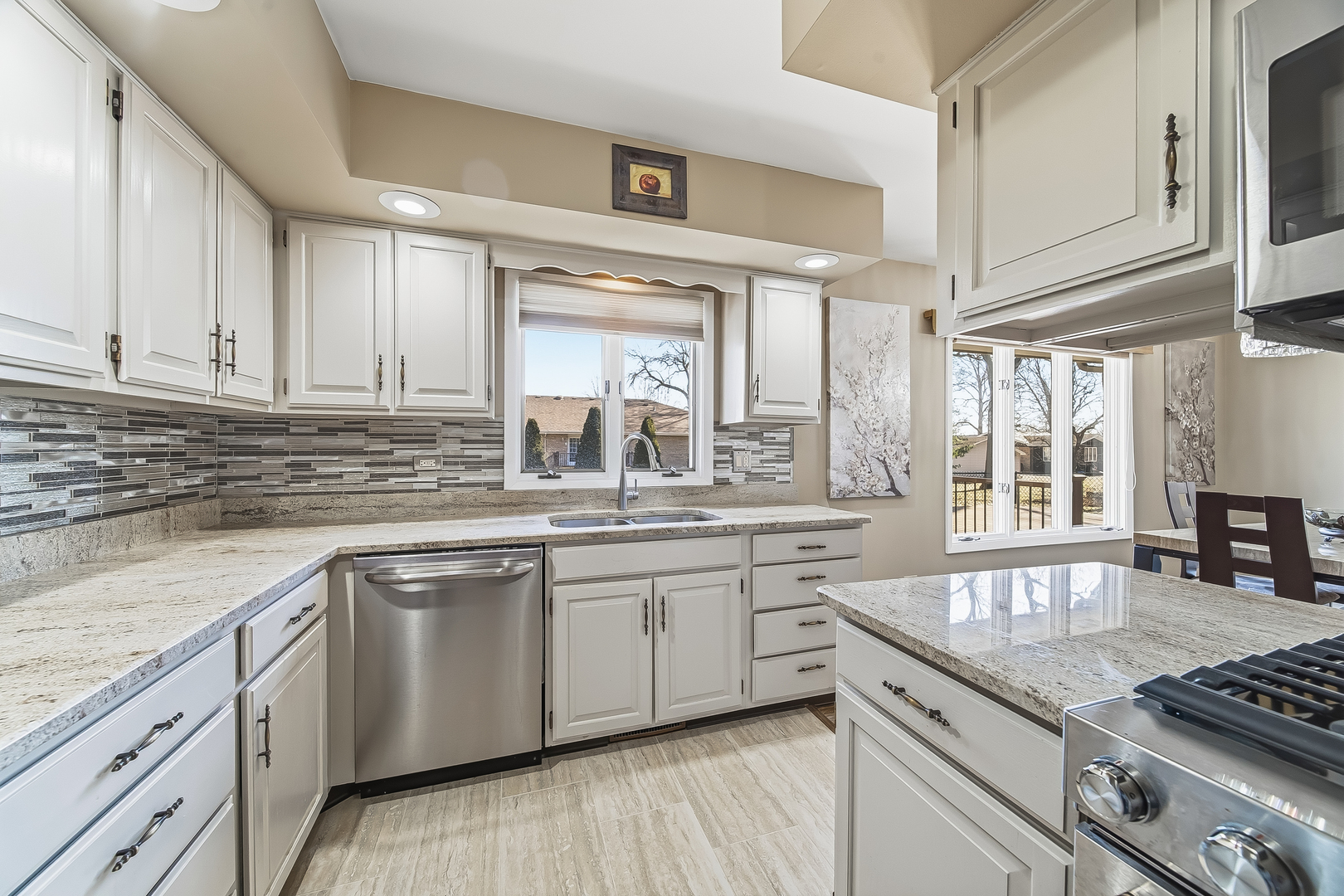 18317 Harper Street Lansing, IL 60438 - Photo 9 of 26 a kitchen with stainless steel appliances granite countertop a sink stove and cabinets