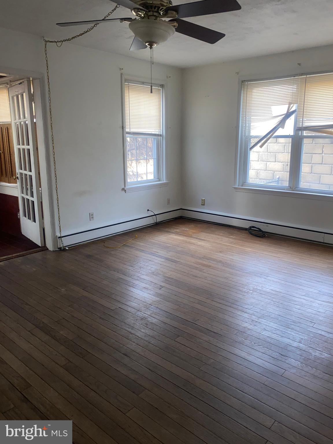 5817 Keystone Street, Unit A Philadelphia, PA 19135 - Photo 12 of 27 an empty room with wooden floor and windows