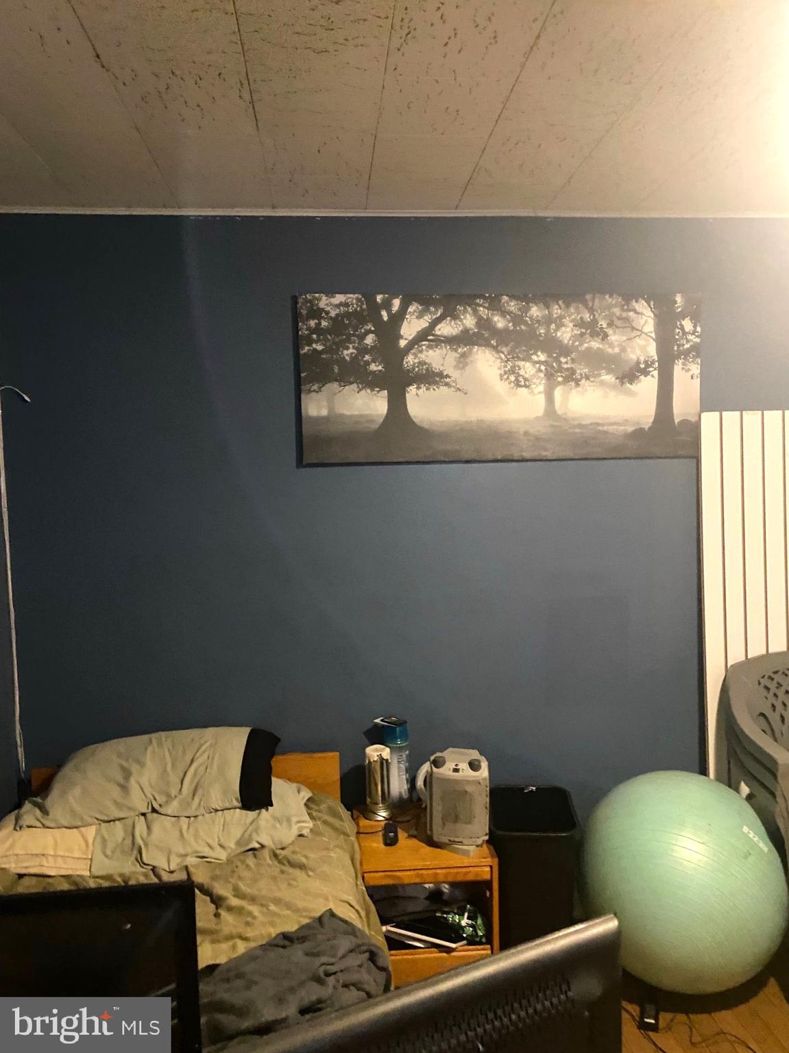 5817 Keystone Street, Unit A Philadelphia, PA 19135 - Photo 26 of 27 a bed sitting in a bedroom next to a window