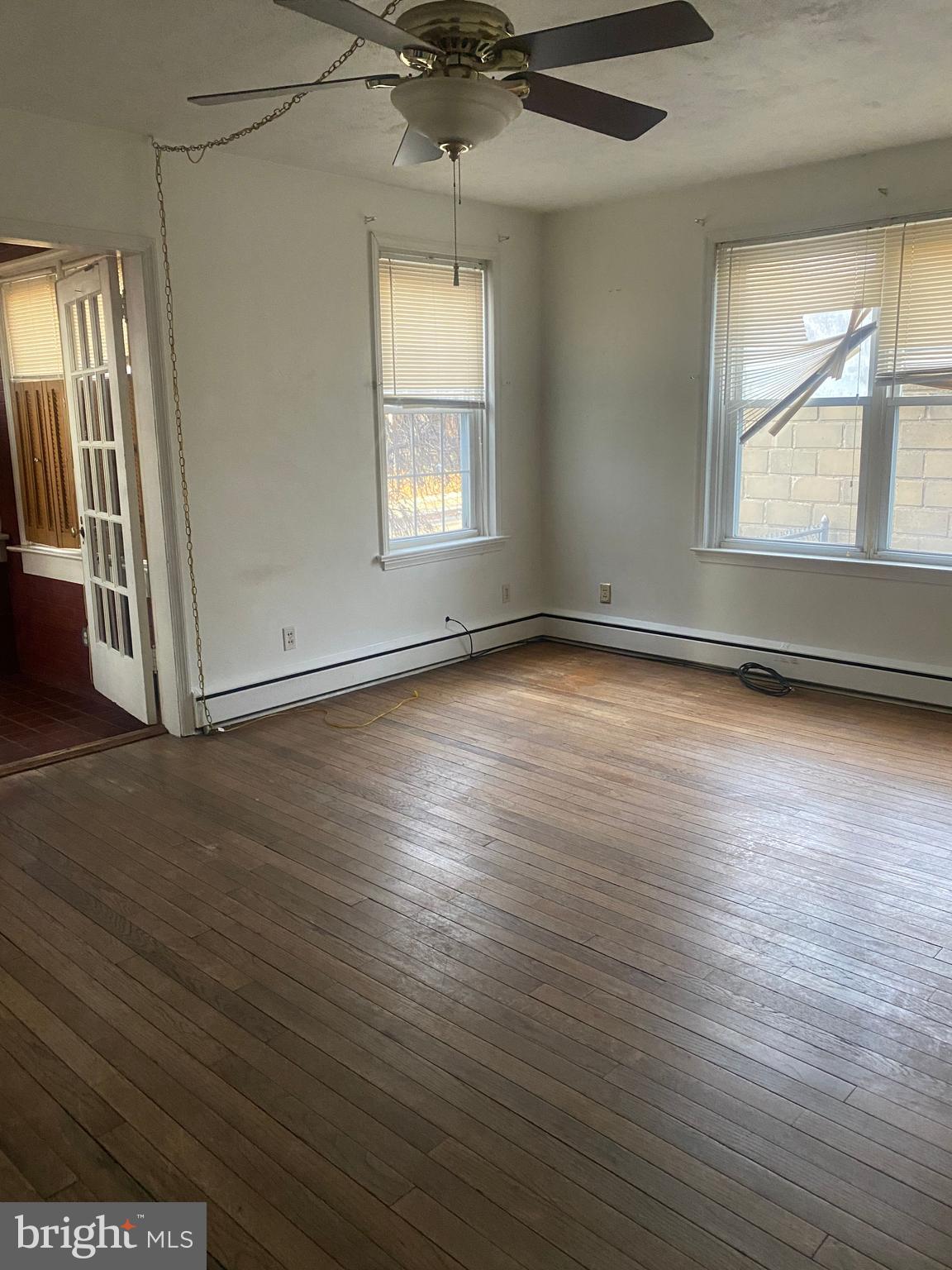 5817 Keystone Street, Unit A Philadelphia, PA 19135 - Photo 9 of 27 an empty room with wooden floor and windows