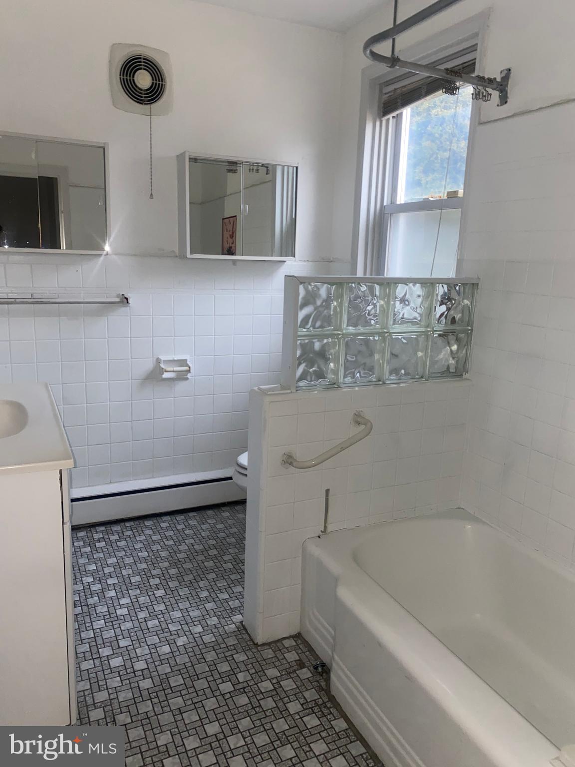 5817 Keystone Street, Unit A Philadelphia, PA 19135 - Photo 10 of 27 a bathroom with a bathtub a window and a shower