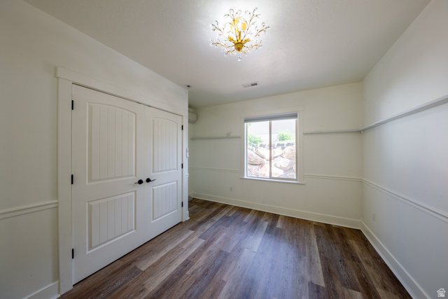 868 Braddock Lane Alpine, UT 84004 - Photo 52 of 64 Spacious room featuring wood-finish flooring, white paneled double closet doors, and decorative wainscoting