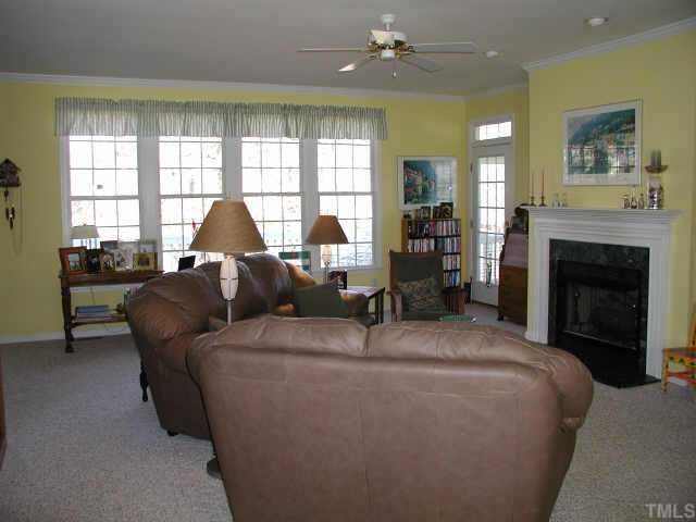 700 Neuse Ridge Drive Clayton, NC 27527 - Photo 7 of 10 a living room with furniture a large window and a fireplace