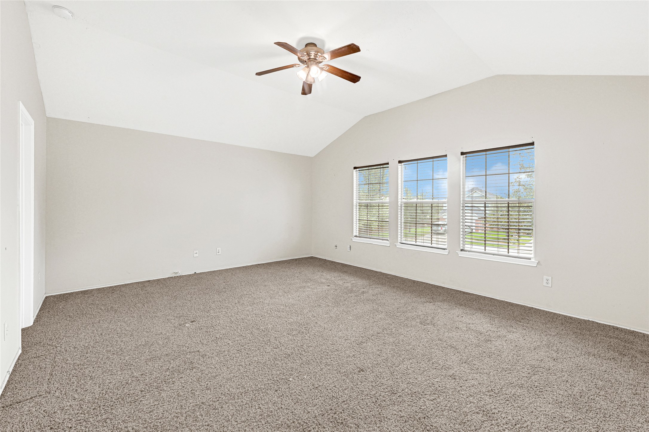 3431 Princeton Point Court Houston, TX 77047 - Photo 12 of 23 an empty room with windows and a ceiling fan