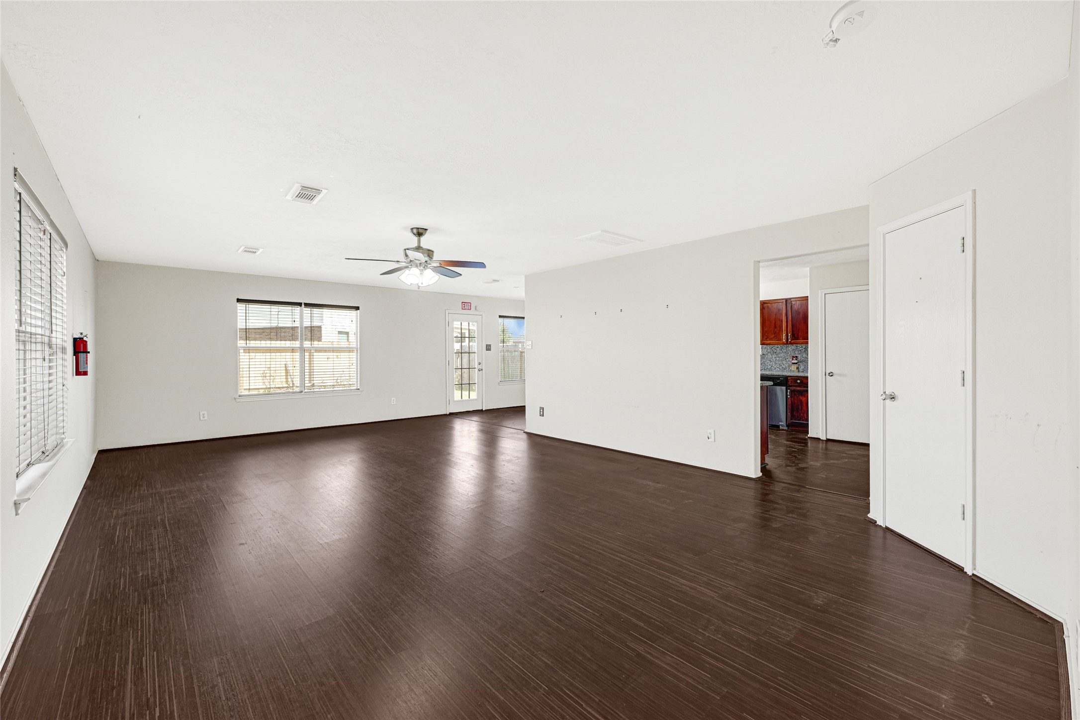 3431 Princeton Point Court Houston, TX 77047 - Photo 4 of 23 an empty room with wooden floor and windows