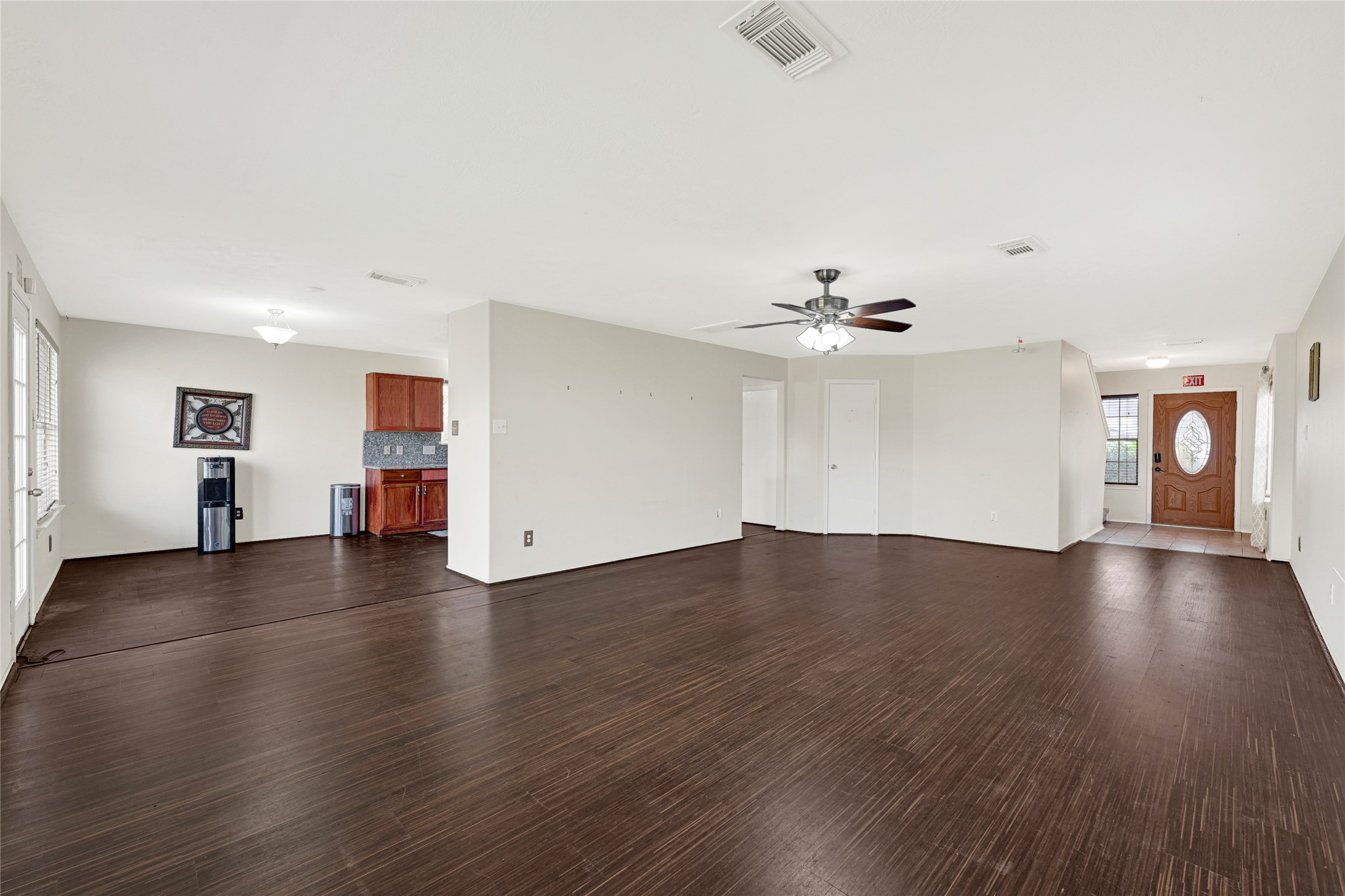 3431 Princeton Point Court Houston, TX 77047 - Photo 5 of 23 a view of an empty room with wooden floor and a ceiling fan
