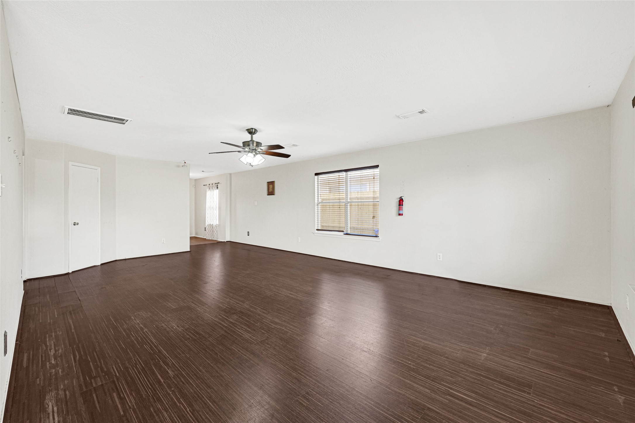 3431 Princeton Point Court Houston, TX 77047 - Photo 6 of 23 a view of empty room with wooden floor and fan