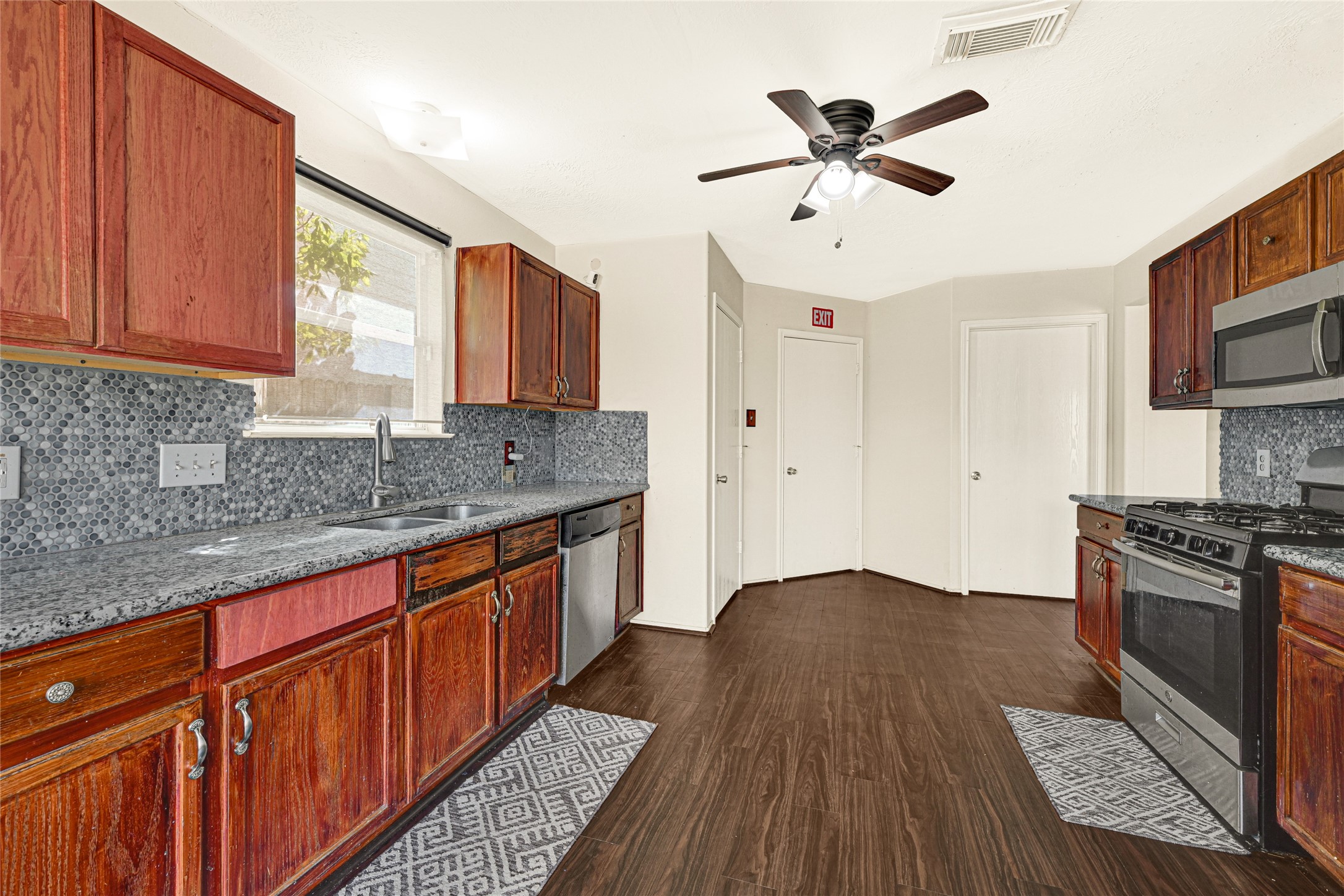 3431 Princeton Point Court Houston, TX 77047 - Photo 7 of 23 a kitchen with stainless steel appliances granite countertop a sink stove and refrigerator