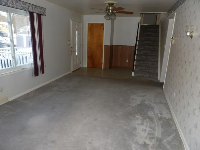 an empty room with windows and entrance