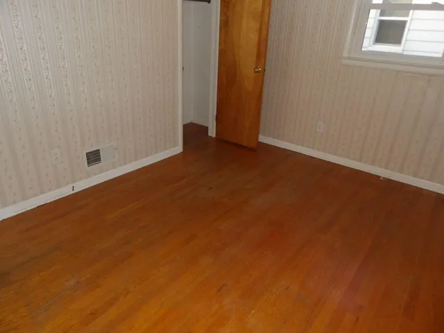 an empty room with wooden floor