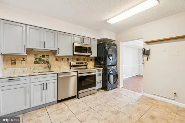 a kitchen with a sink stove and refrigerator