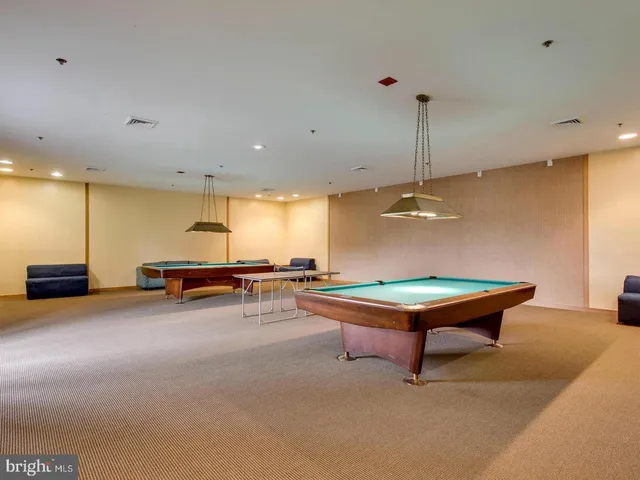 a room with furniture pool table and a projector screen