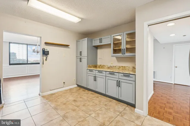 a spacious bathroom with a granite countertop sink a mirror and a vanity