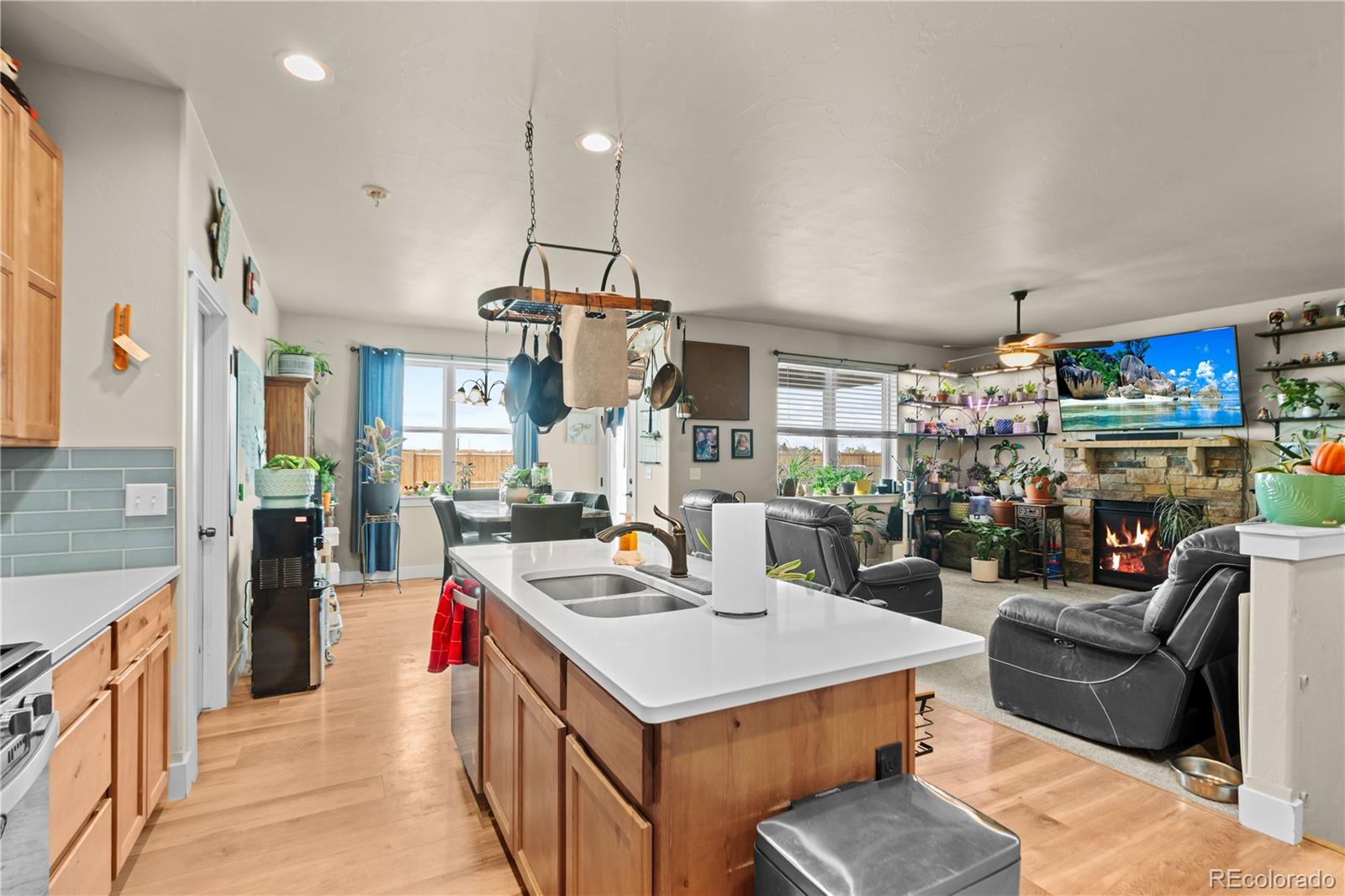 109 7th Avenue Wiggins, CO 80654 - Photo 11 of 38 a living room with stainless steel appliances kitchen island granite countertop a stove and a sink