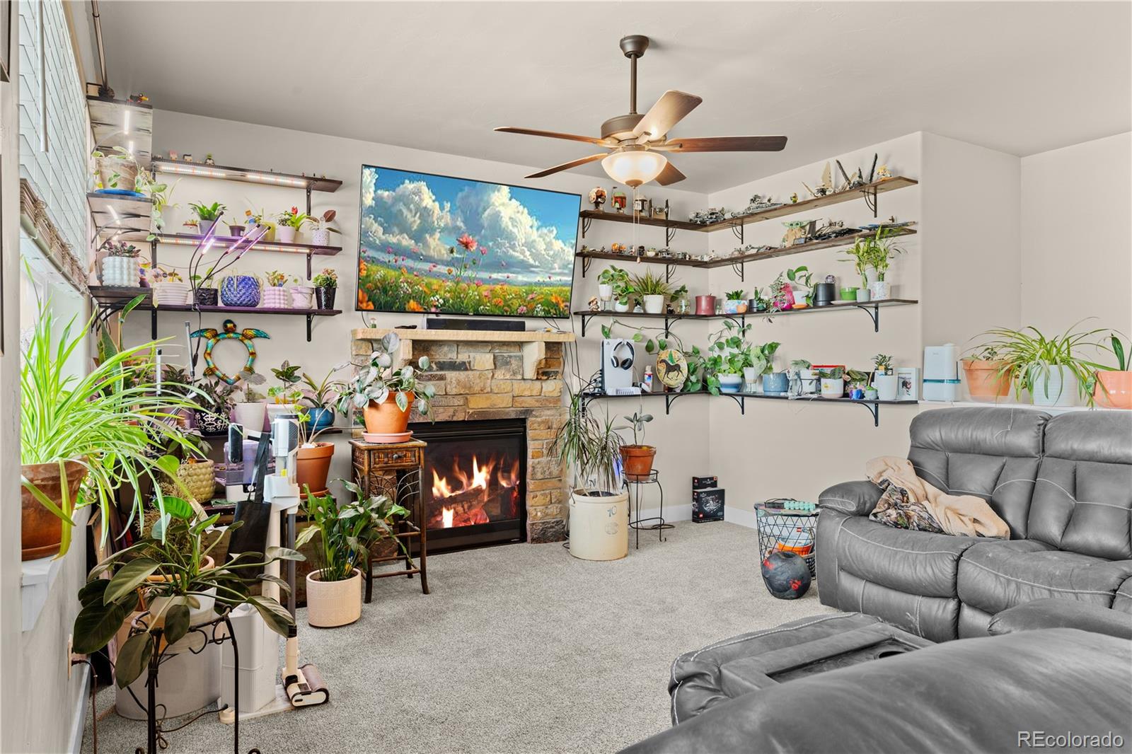 109 7th Avenue Wiggins, CO 80654 - Photo 15 of 38 a living room with patio furniture and a fireplace