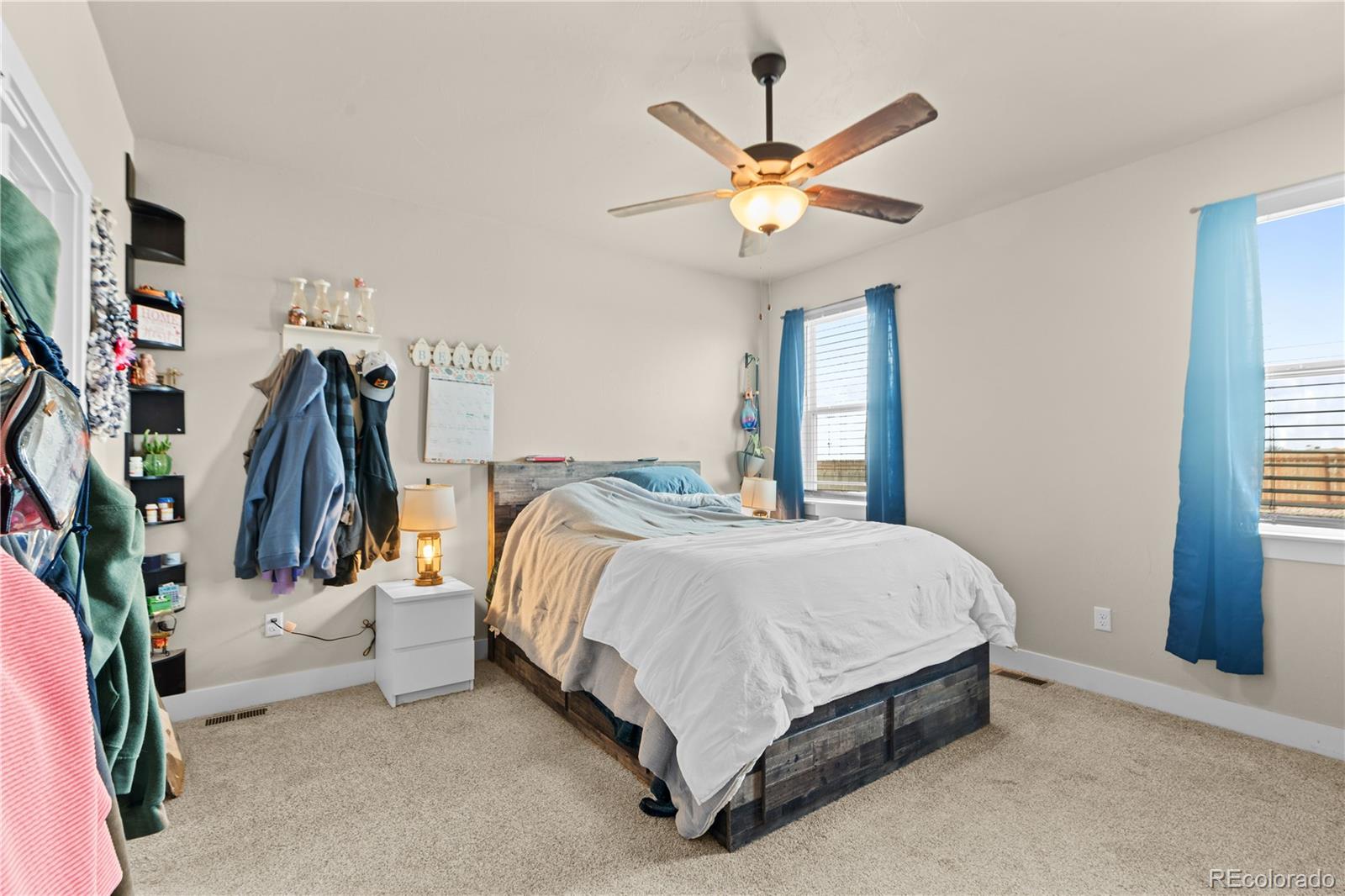 109 7th Avenue Wiggins, CO 80654 - Photo 18 of 38 a bed room with a bed and a chandelier