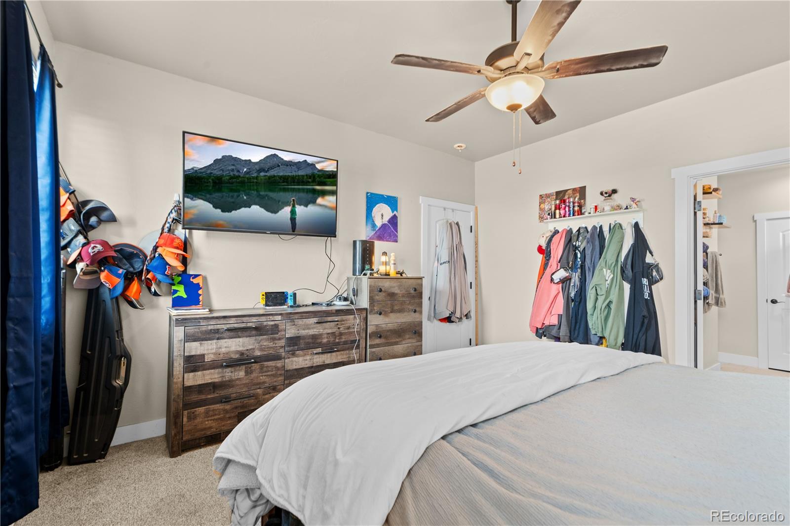 109 7th Avenue Wiggins, CO 80654 - Photo 20 of 38 a bed room with a bed and a flat screen tv