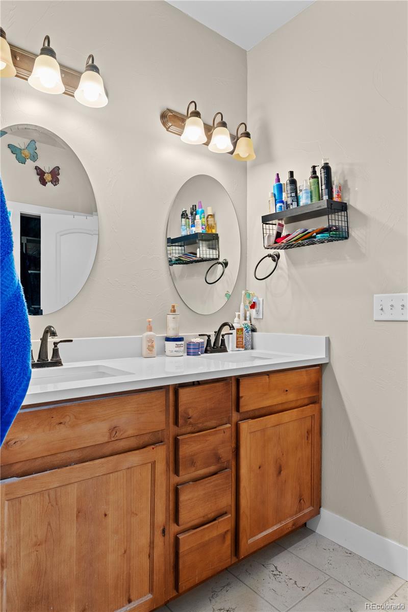 109 7th Avenue Wiggins, CO 80654 - Photo 22 of 38 a bathroom with a sink and a mirror