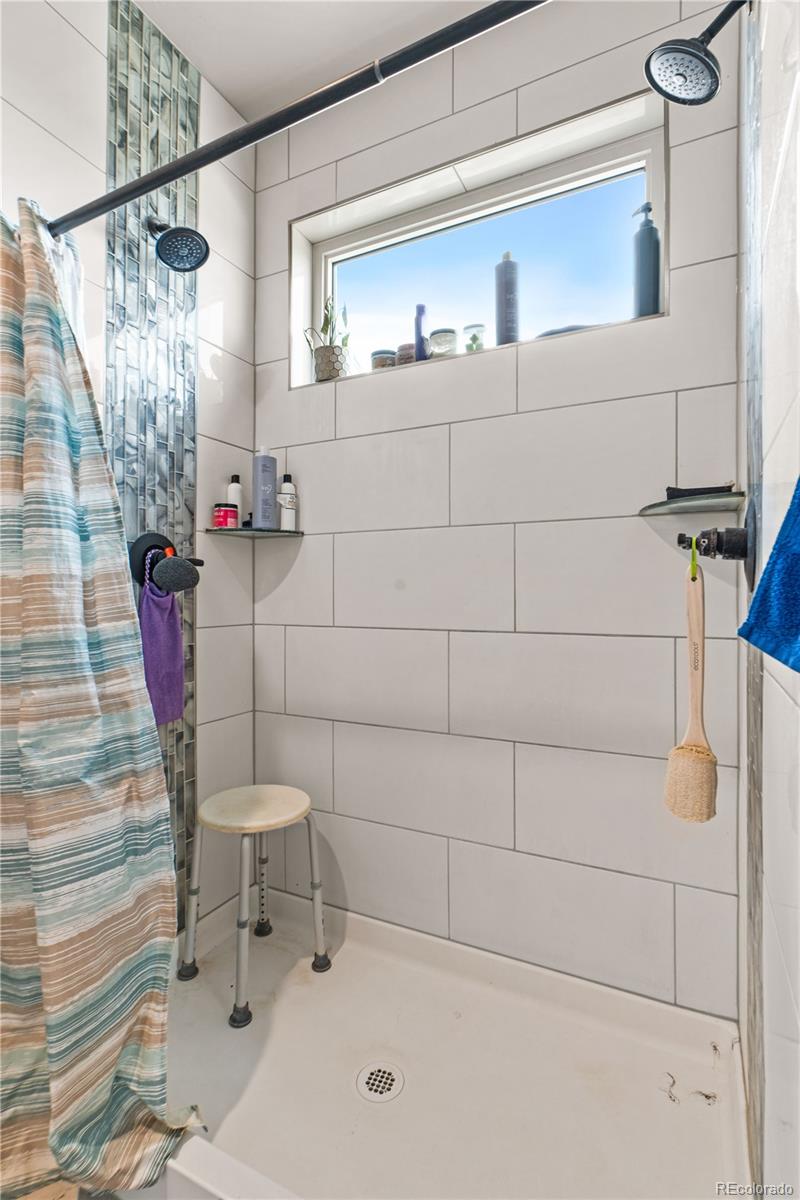 109 7th Avenue Wiggins, CO 80654 - Photo 23 of 38 a bathroom with a sink and a shower