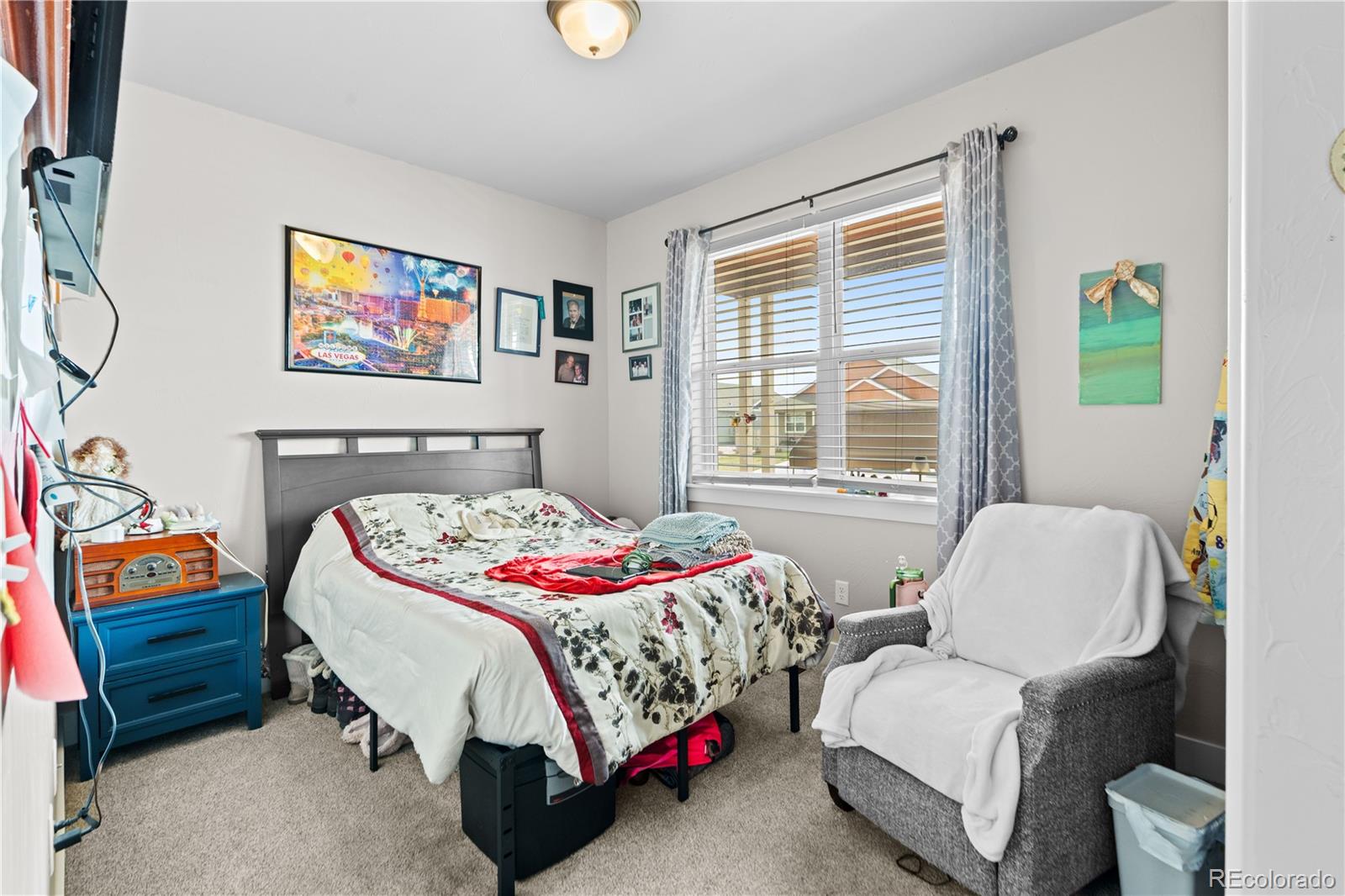 109 7th Avenue Wiggins, CO 80654 - Photo 28 of 38 a bedroom with a bed and a couch