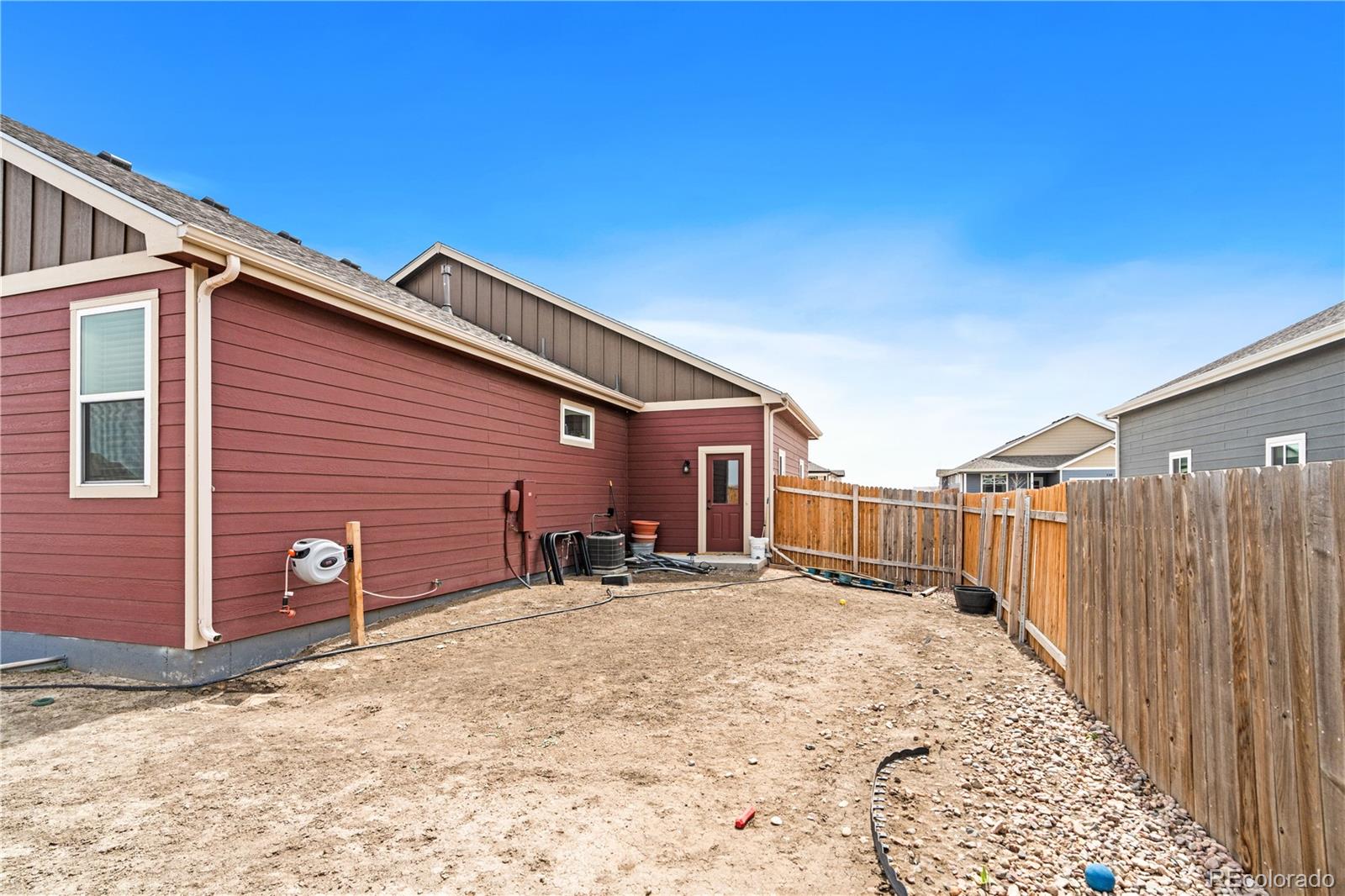 109 7th Avenue Wiggins, CO 80654 - Photo 35 of 38 a view of a backyard with a small cabin and a chair