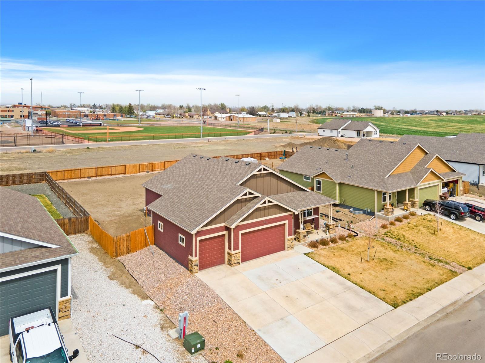 109 7th Avenue Wiggins, CO 80654 - Photo 37 of 38 an aerial view of residential houses with outdoor space