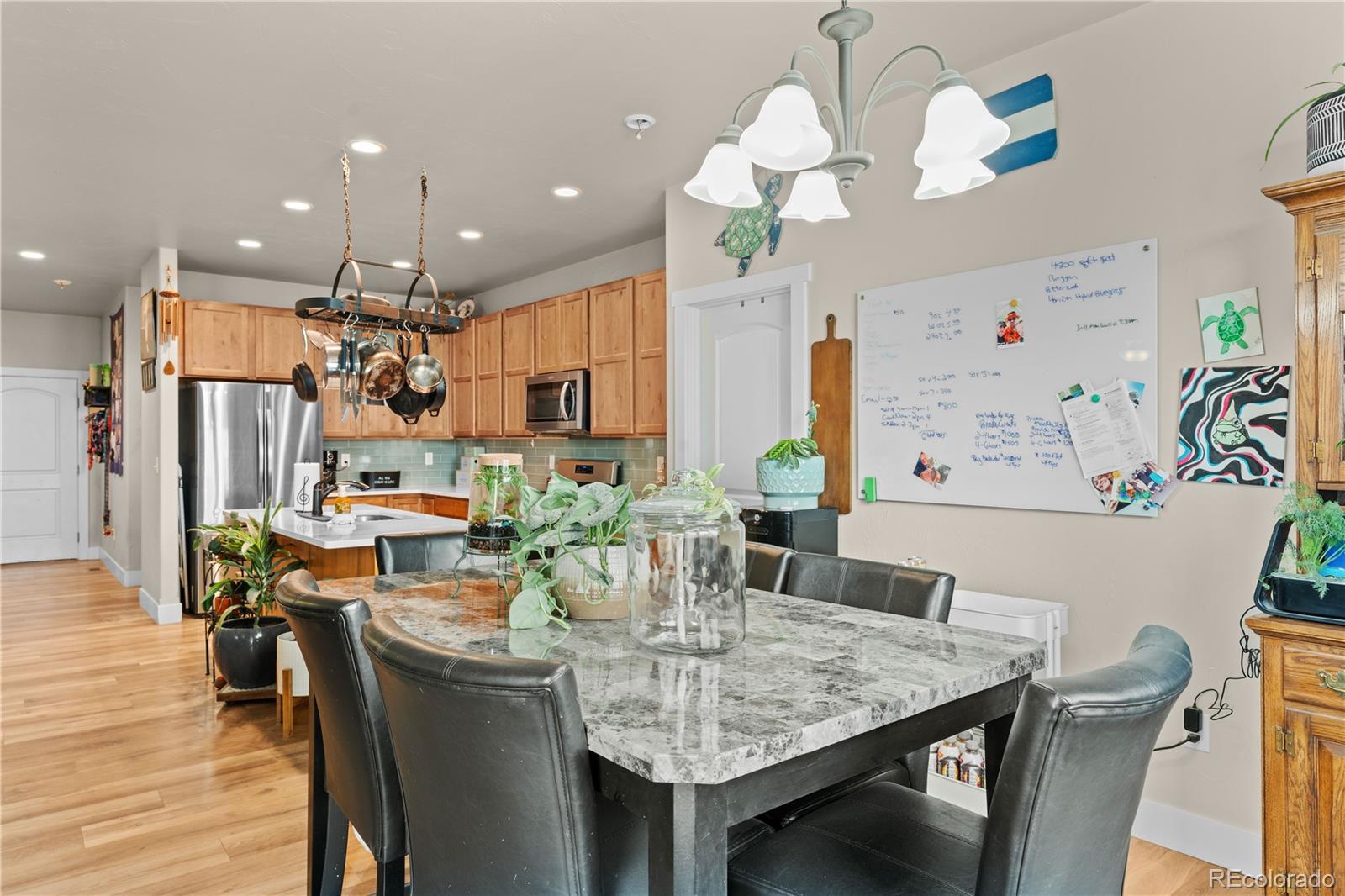 109 7th Avenue Wiggins, CO 80654 - Photo 10 of 38 a view of a dining room with furniture and wooden floor