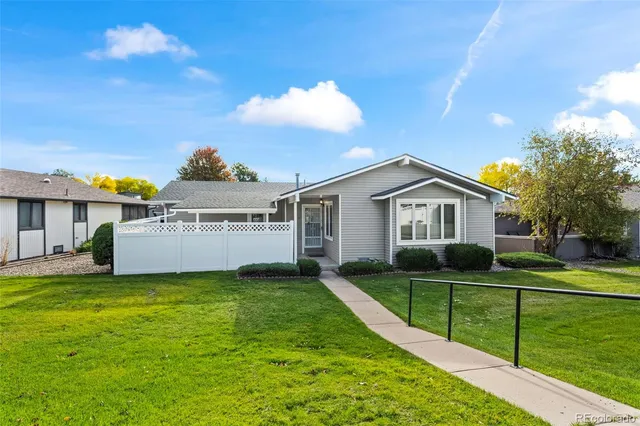 a view of a house with a yard and sitting area