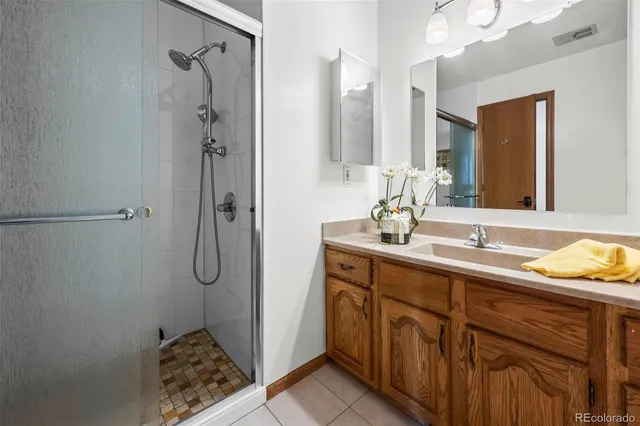a bathroom with a sink mirror and a shower