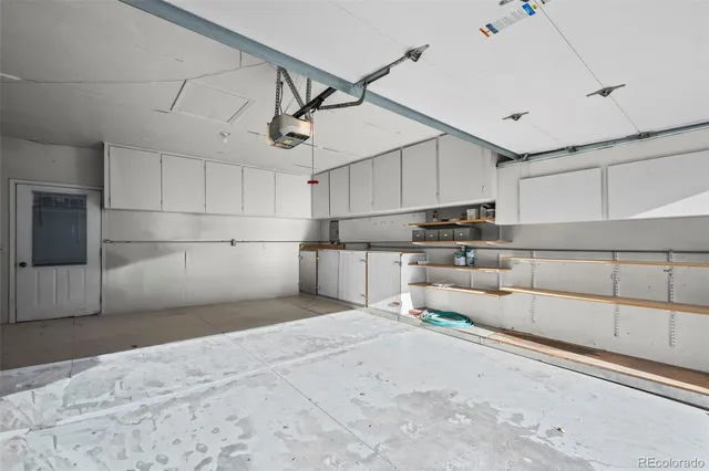 a view of a kitchen with cabinet and a refrigerator