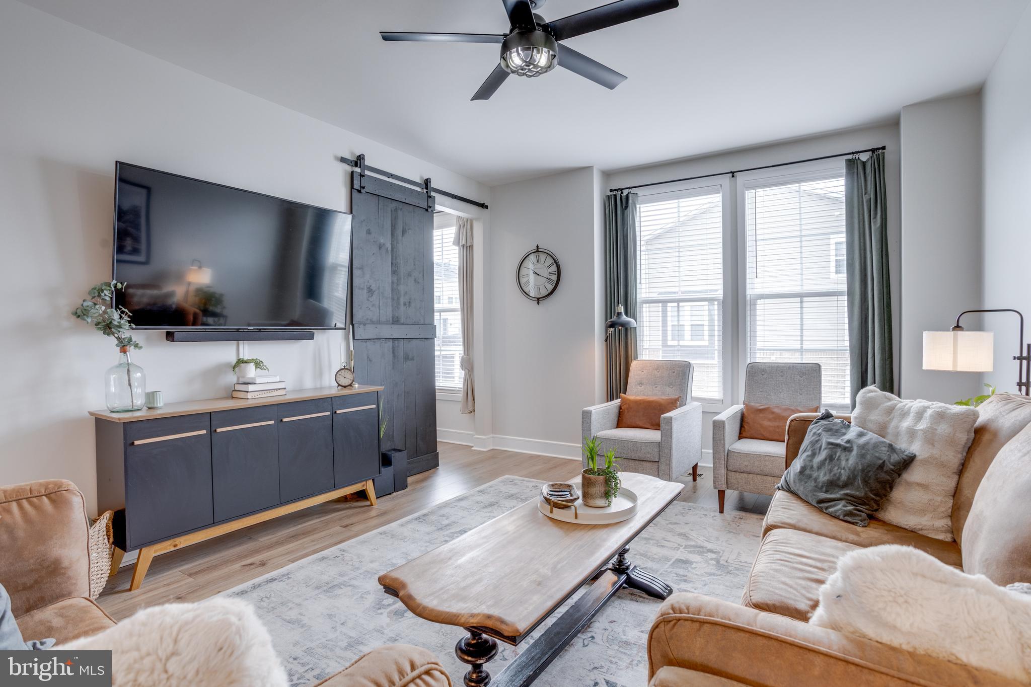 14488 Nebbiolo Drive Gainesville, VA 20155 - Photo 18 of 54 a living room with furniture and a flat screen tv