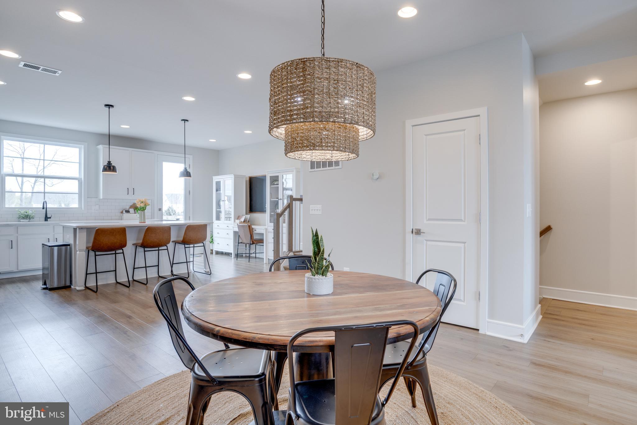 14488 Nebbiolo Drive Gainesville, VA 20155 - Photo 19 of 54 a view of a dining room with furniture wooden floor and chandelier