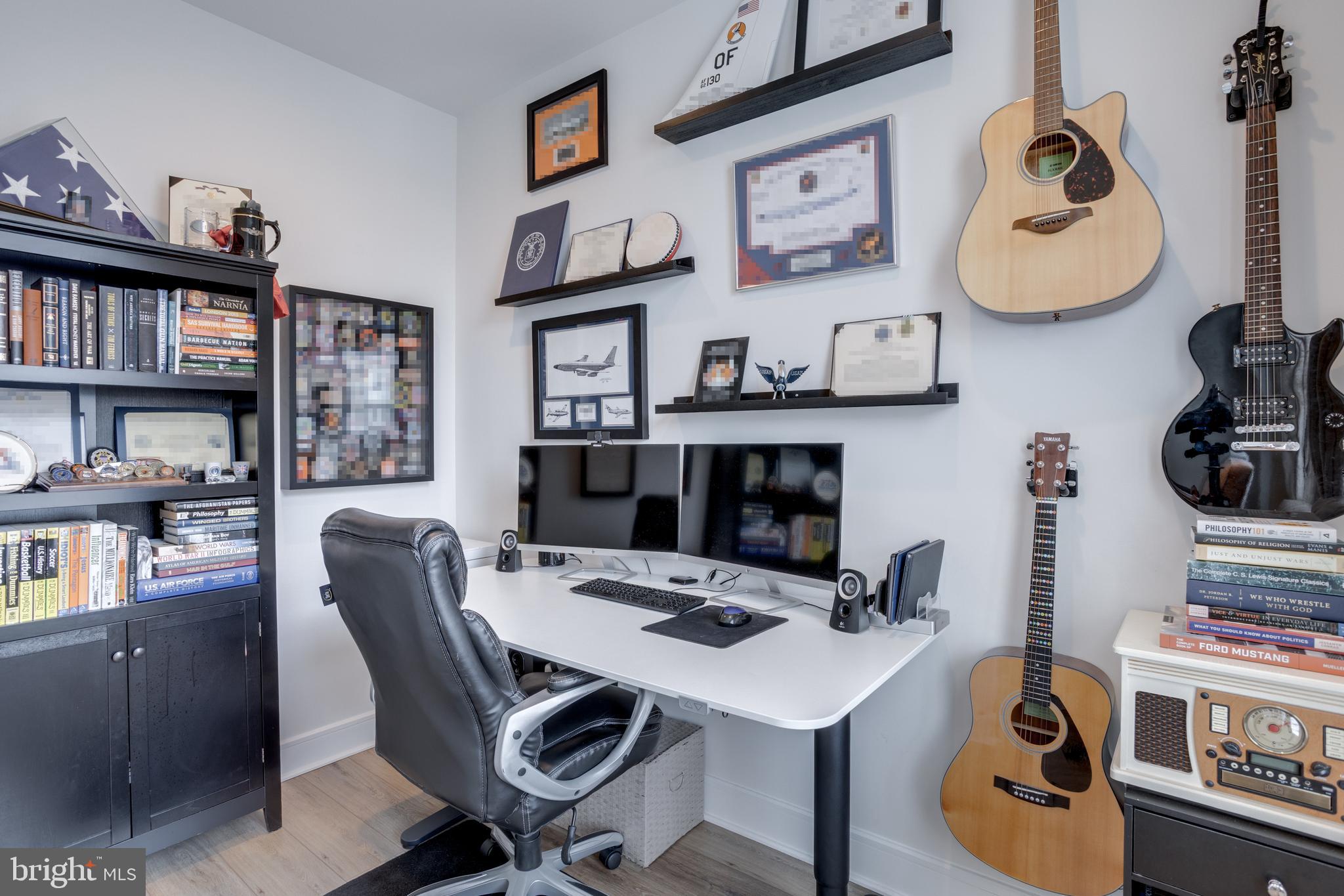 14488 Nebbiolo Drive Gainesville, VA 20155 - Photo 20 of 54 a view of a workspace with furniture and a bookshelf