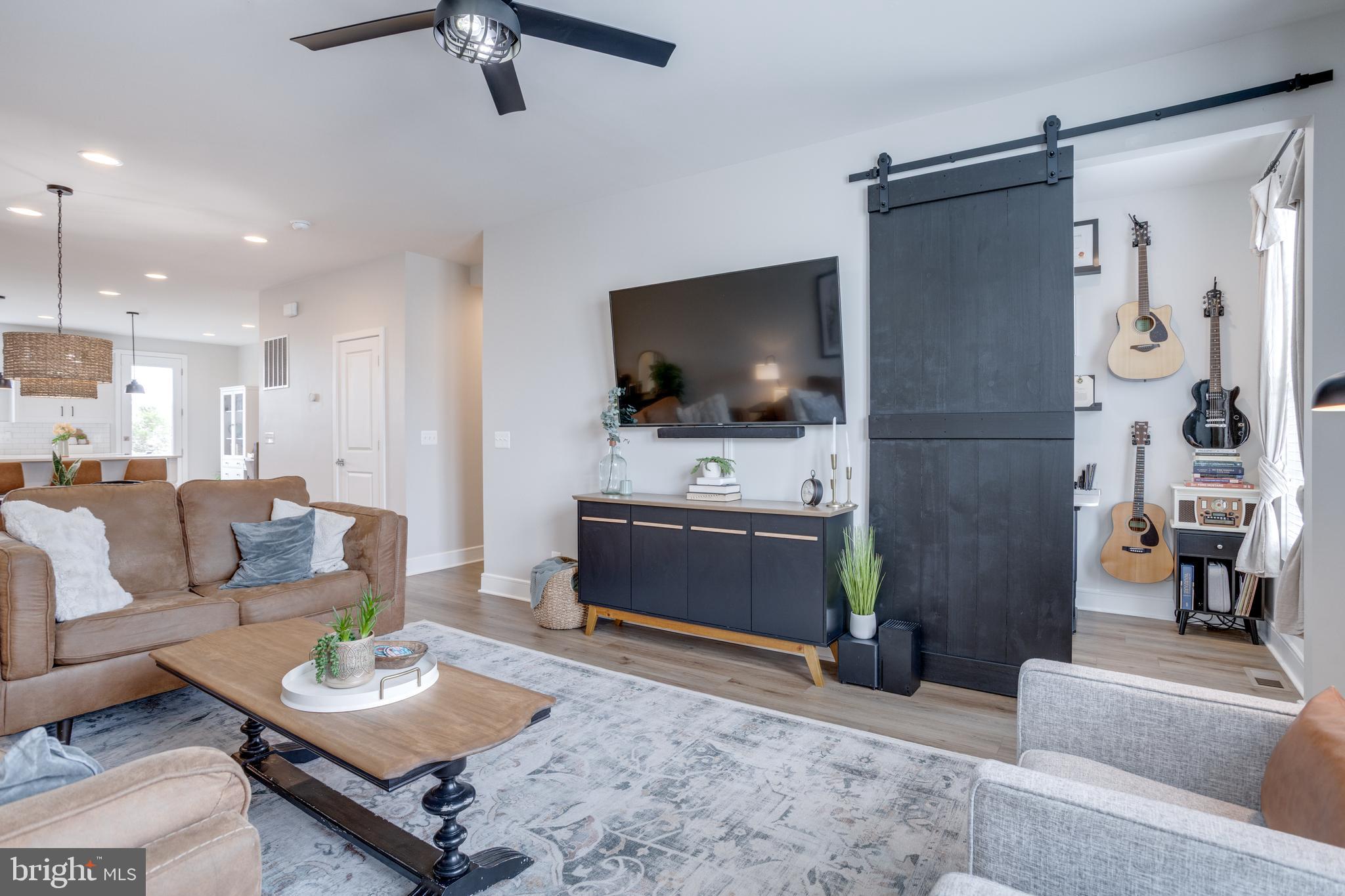 14488 Nebbiolo Drive Gainesville, VA 20155 - Photo 21 of 54 a living room with furniture and a flat screen tv