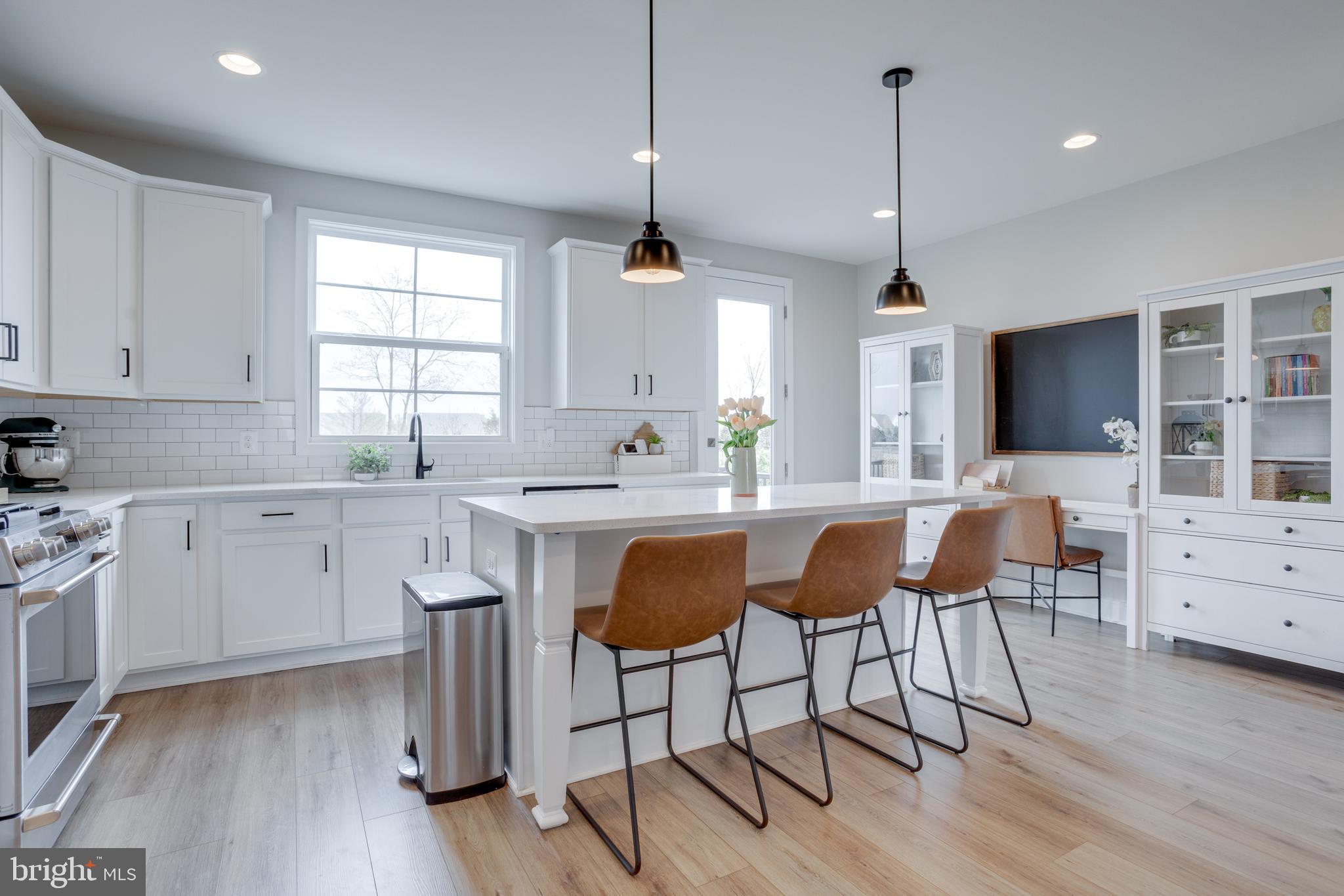14488 Nebbiolo Drive Gainesville, VA 20155 - Photo 23 of 54 a kitchen with granite countertop a sink cabinets and wooden floor