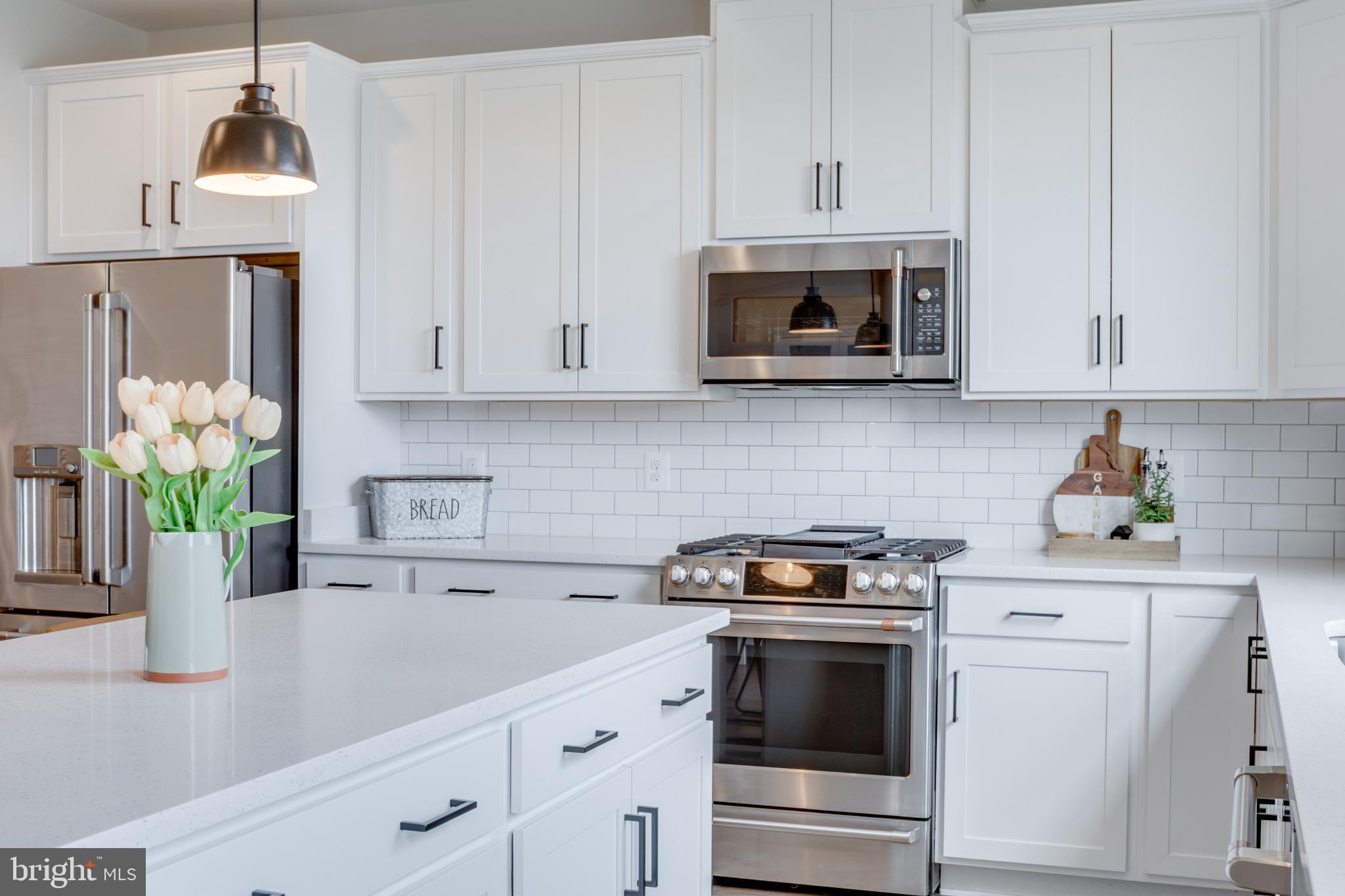 14488 Nebbiolo Drive Gainesville, VA 20155 - Photo 28 of 54 a kitchen with stainless steel appliances white cabinets and a stove