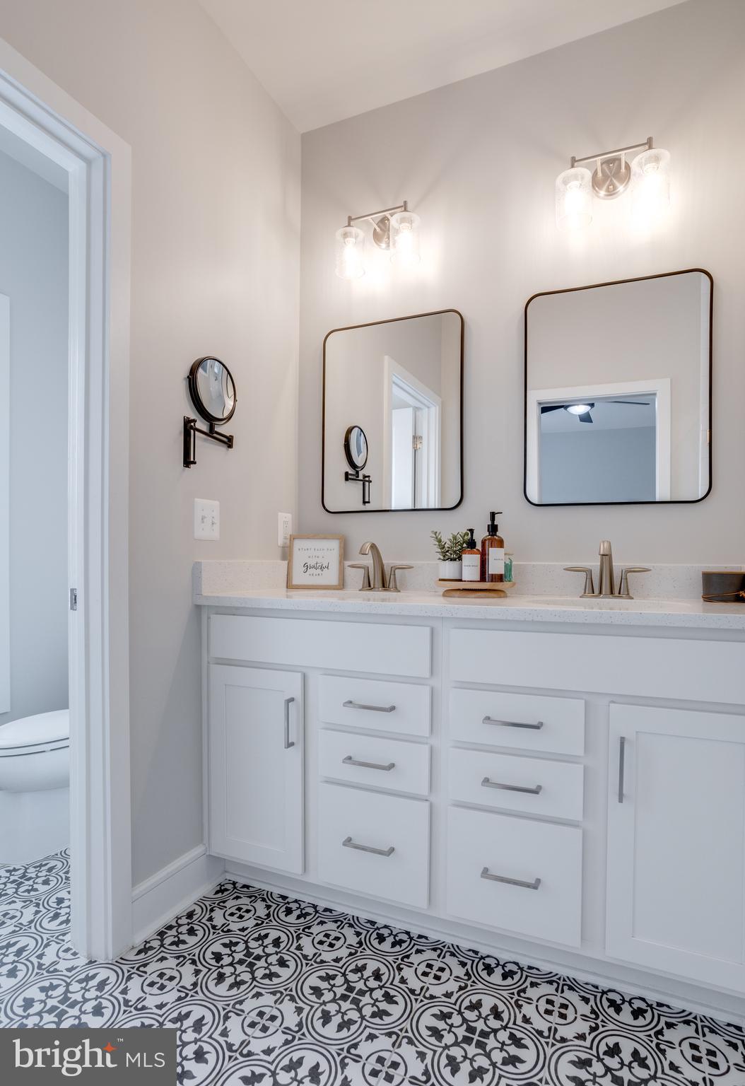 14488 Nebbiolo Drive Gainesville, VA 20155 - Photo 36 of 54 a bathroom with a toilet a sink a mirror and vanity