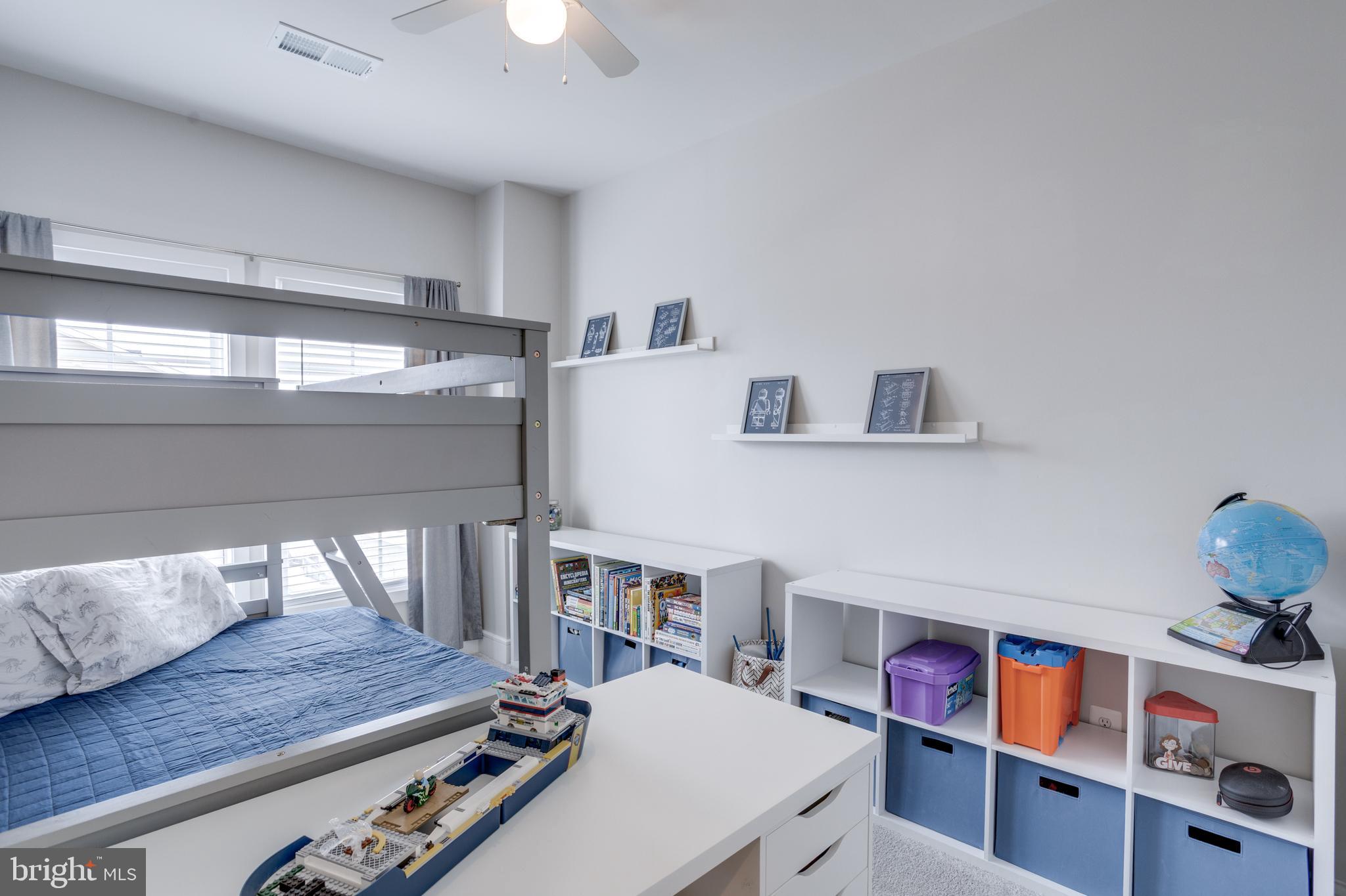 14488 Nebbiolo Drive Gainesville, VA 20155 - Photo 40 of 54 a living room with furniture and a book shelf