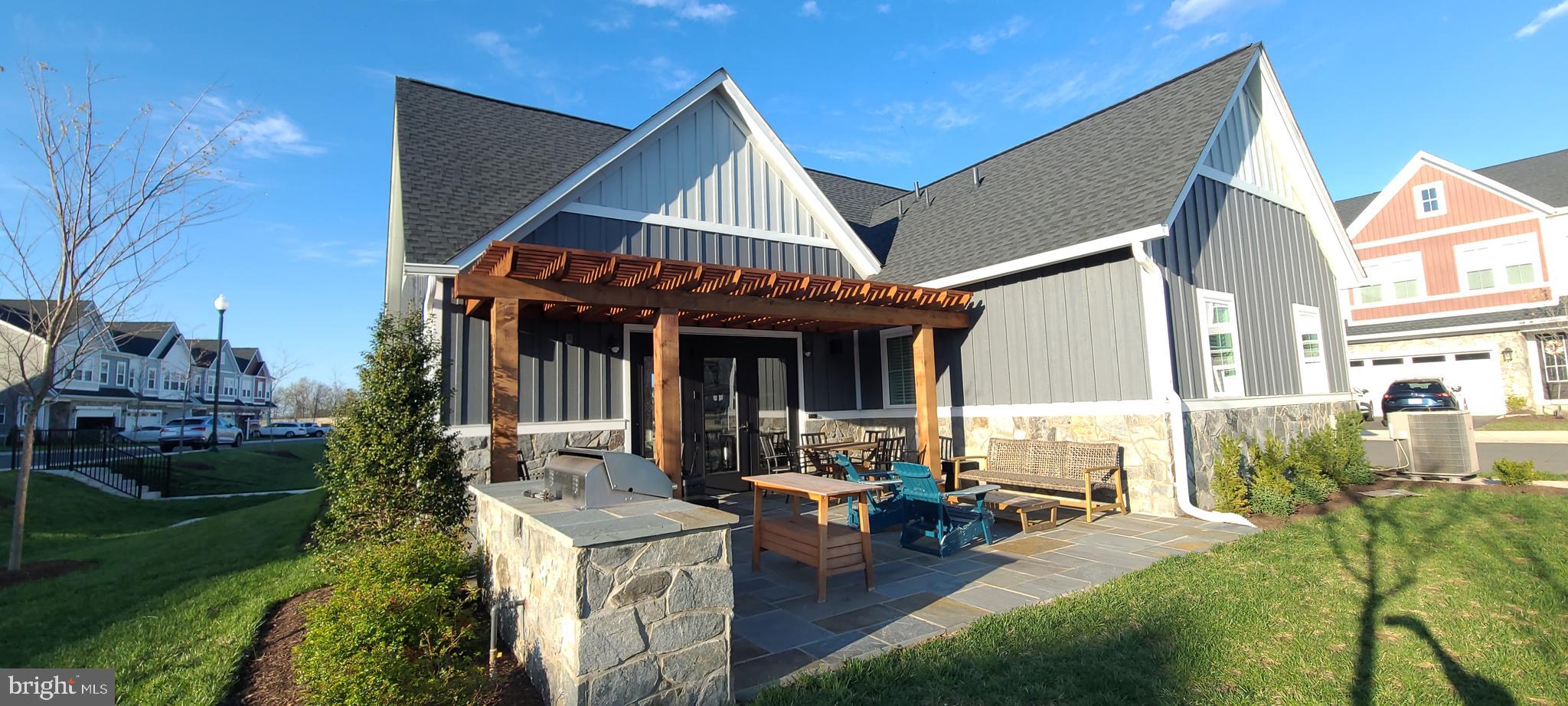 14488 Nebbiolo Drive Gainesville, VA 20155 - Photo 48 of 54 a view of a house with sitting area and garden