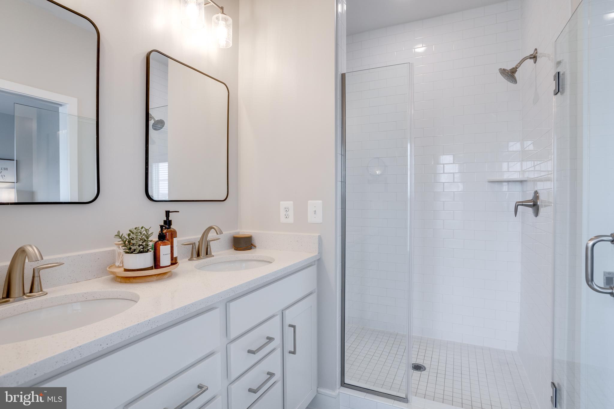 14488 Nebbiolo Drive Gainesville, VA 20155 - Photo 6 of 54 a bathroom with a double vanity sink mirror and shower
