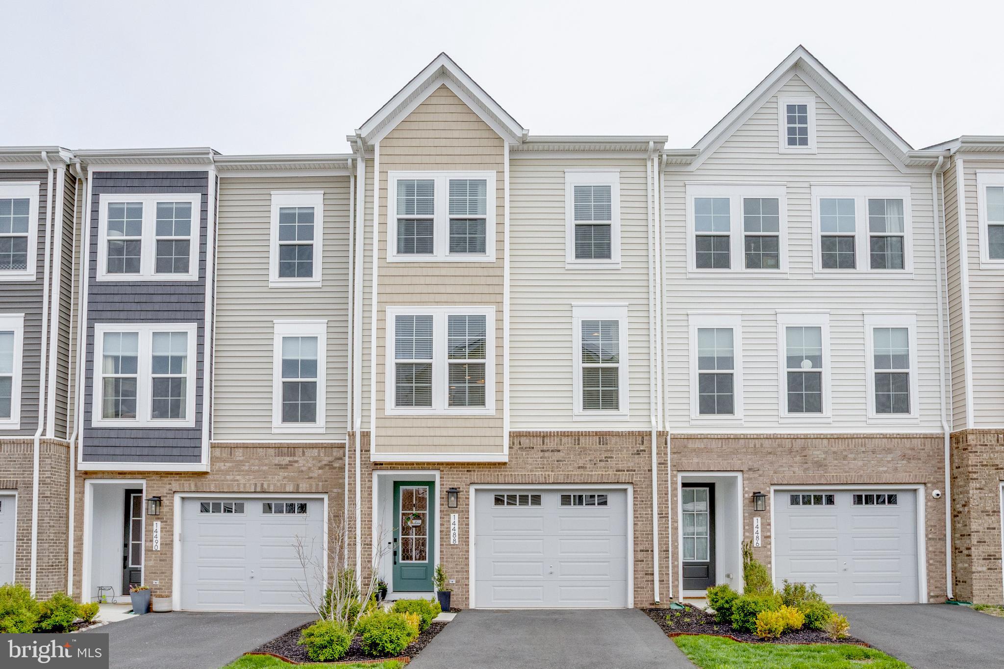 14488 Nebbiolo Drive Gainesville, VA 20155 - Photo 9 of 54 a front view of a building with many windows and a yard