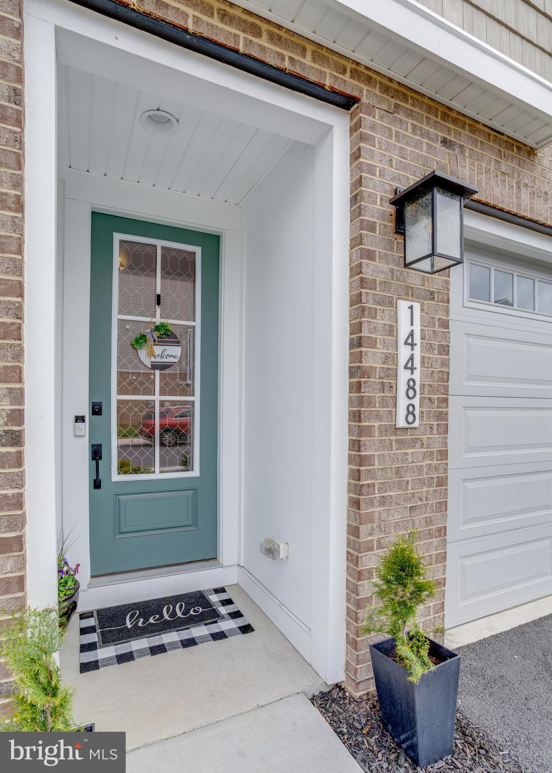 14488 Nebbiolo Drive Gainesville, VA 20155 - Photo 10 of 54 a front view of a house with potted plants