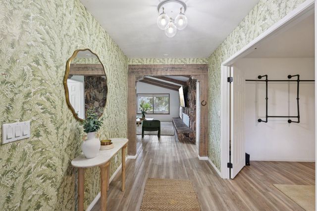 a living room with furniture and a view of kitchen