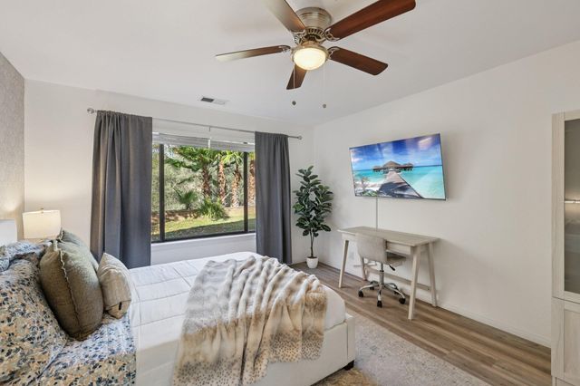 a view of a house with a yard and a fountain