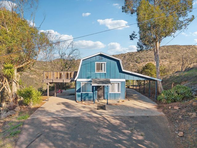 a living room with furniture a air conditioner vent and a window