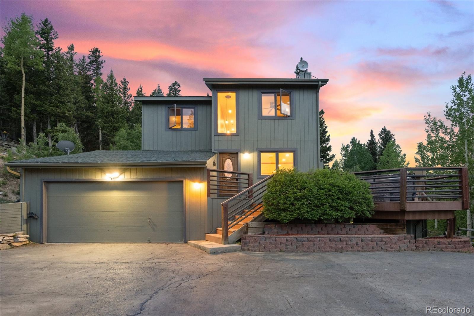 1682 Sinton Road Evergreen, CO 80439 - Photo 1 of 40 a front view of a house with a yard