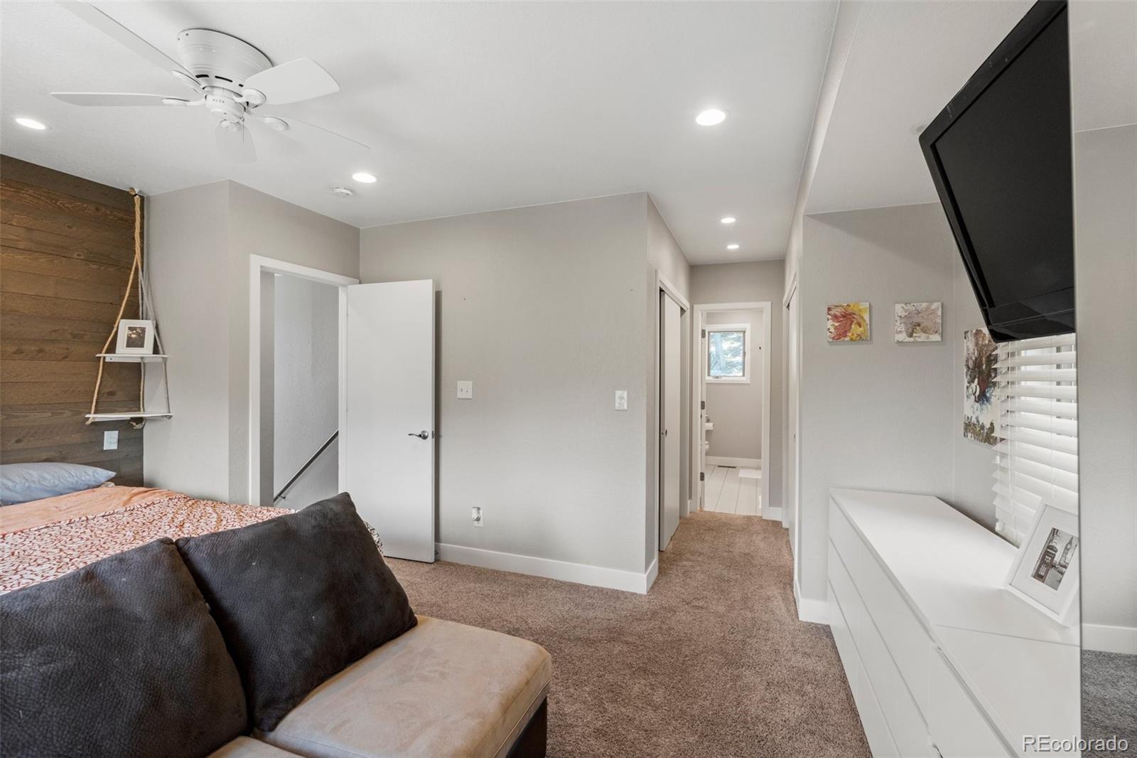1682 Sinton Road Evergreen, CO 80439 - Photo 20 of 40 a living room with furniture and a flat screen tv