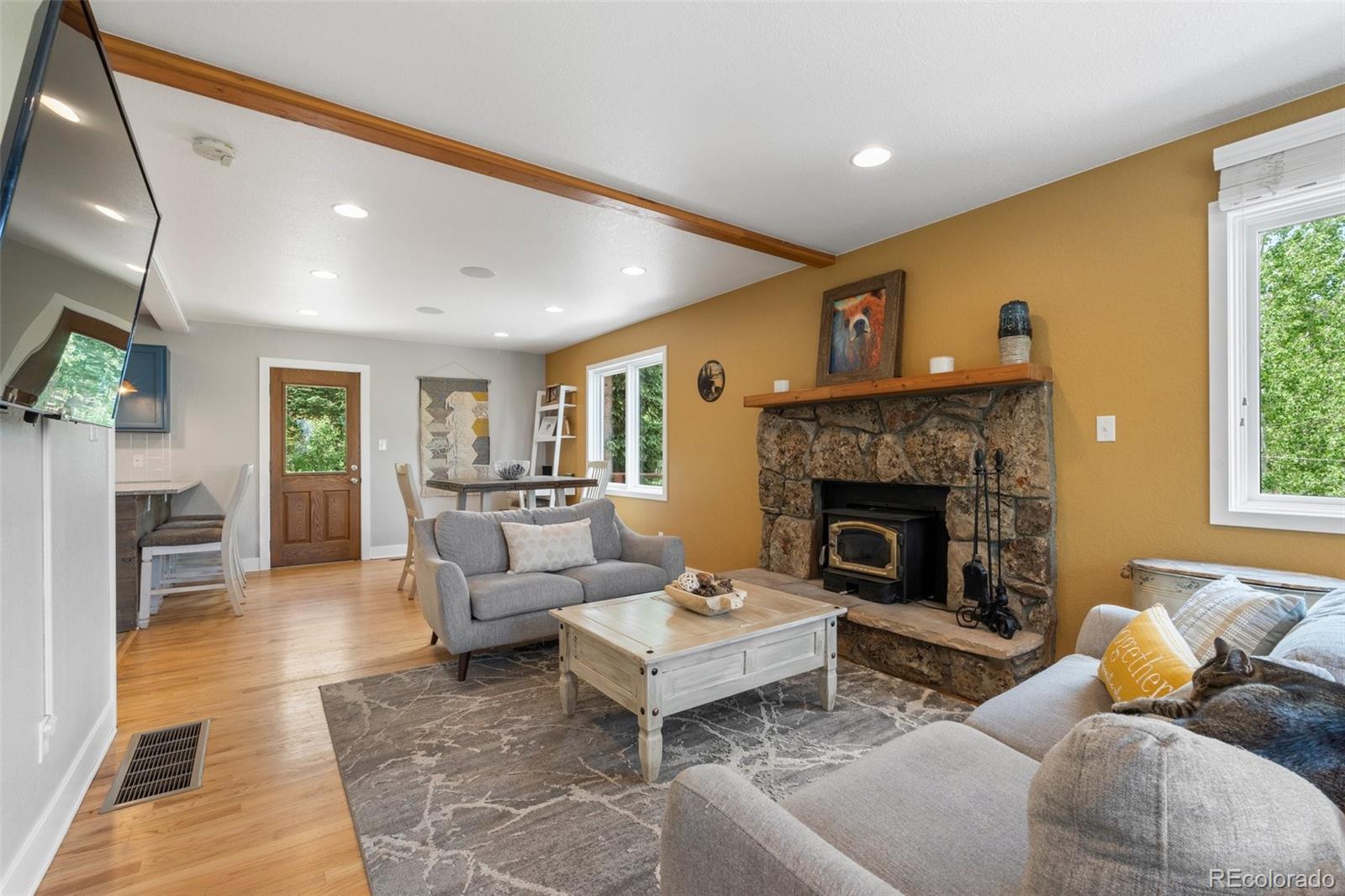 1682 Sinton Road Evergreen, CO 80439 - Photo 3 of 40 a living room with furniture and a fireplace